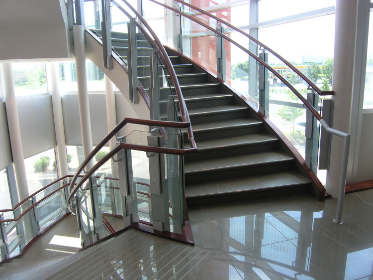Modern glass staircase with sunlight